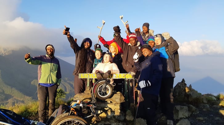 ina akerberg and team on top of mount meru in a wheelchair