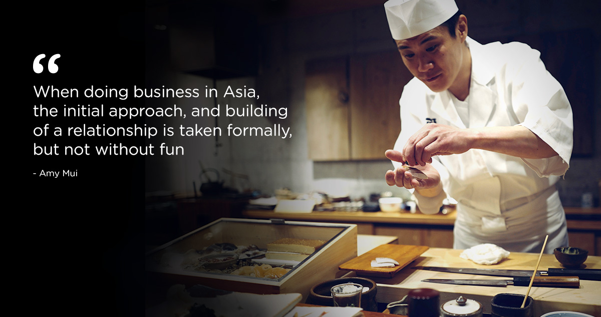 When doing business in Asia, the initial approach, and building of a relationship is taken formally, but not without fun.  Picture of sashimi chef preparing food in well equipped, modern kitchen