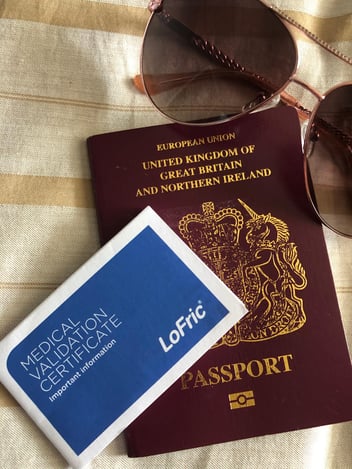 Passport, sunglasses and LoFric Medical Validation Certificate